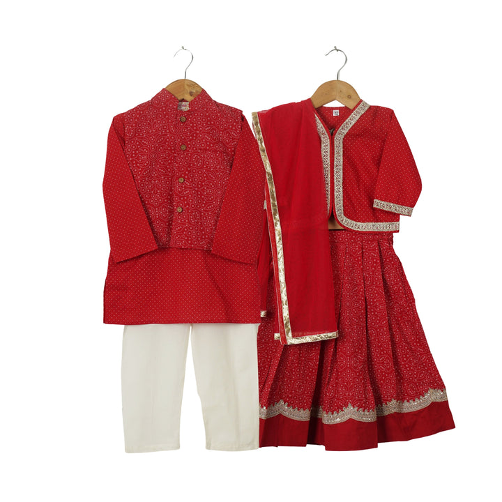 BOYS RED JACKET WITH RED POLKA DOT KURTA AND OFF WHITE PAJAMA (SET OF 3) + GIRLS RED FULL SLEEVES BLOUSE WITH RED LEHENGA AND DUPATTA (SET OF 3)