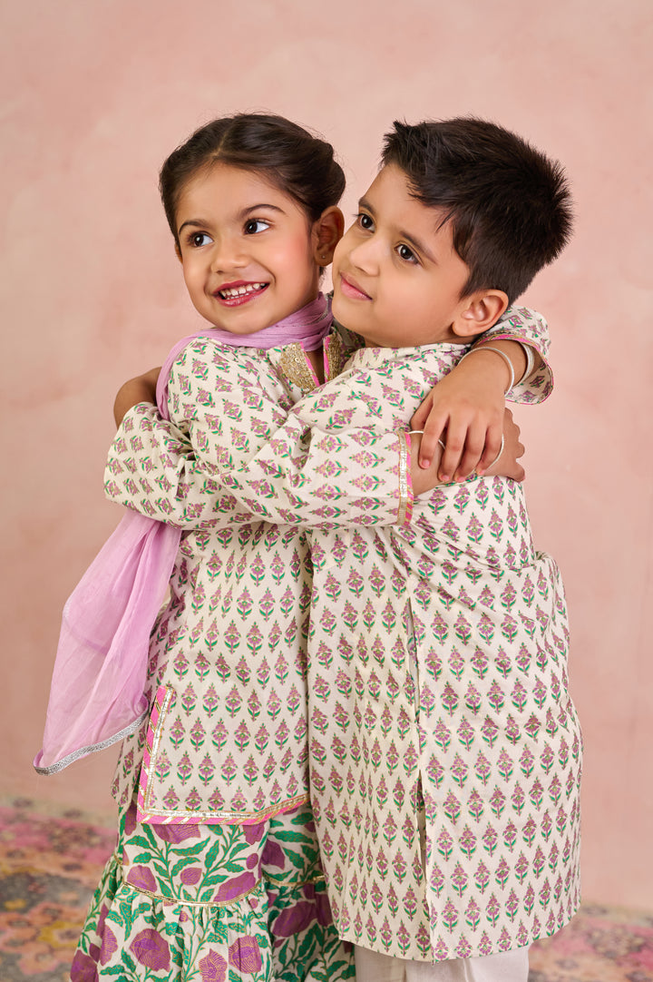 BOYS WHITE GOLD KURTA WITH PAJAMA (SET OF 2) + GIRLS OFF WHITE KURTI WITH PURPLE JAAL SHARARA AND DUPATTA (SET OF 3)