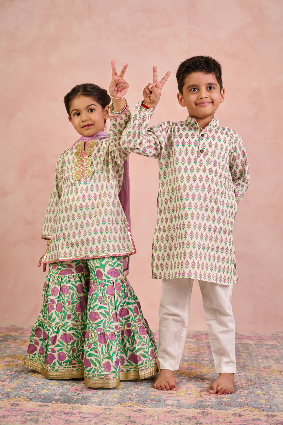 BOYS WHITE GOLD KURTA WITH PAJAMA (SET OF 2) + GIRLS OFF WHITE KURTI WITH PURPLE JAAL SHARARA AND DUPATTA (SET OF 3)
