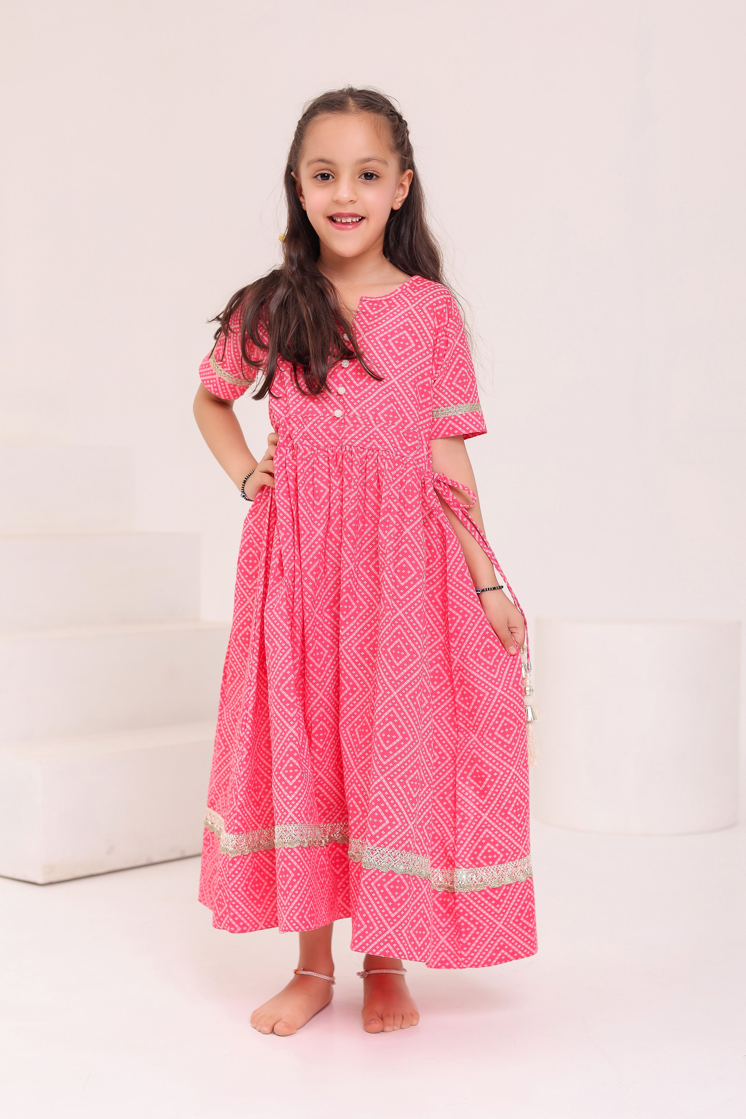 GIRLS PINK BANDHEJ PRINT ANKLE LENGTH ETHNIC GOTA DRESS WITH TASSELS