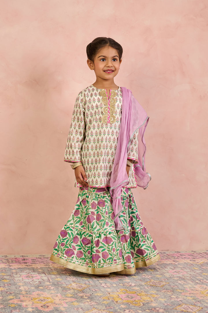 GIRLS OFF WHITE KURTI WITH PURPLE JAAL SHARARA AND DUPATTA (SET OF 3)