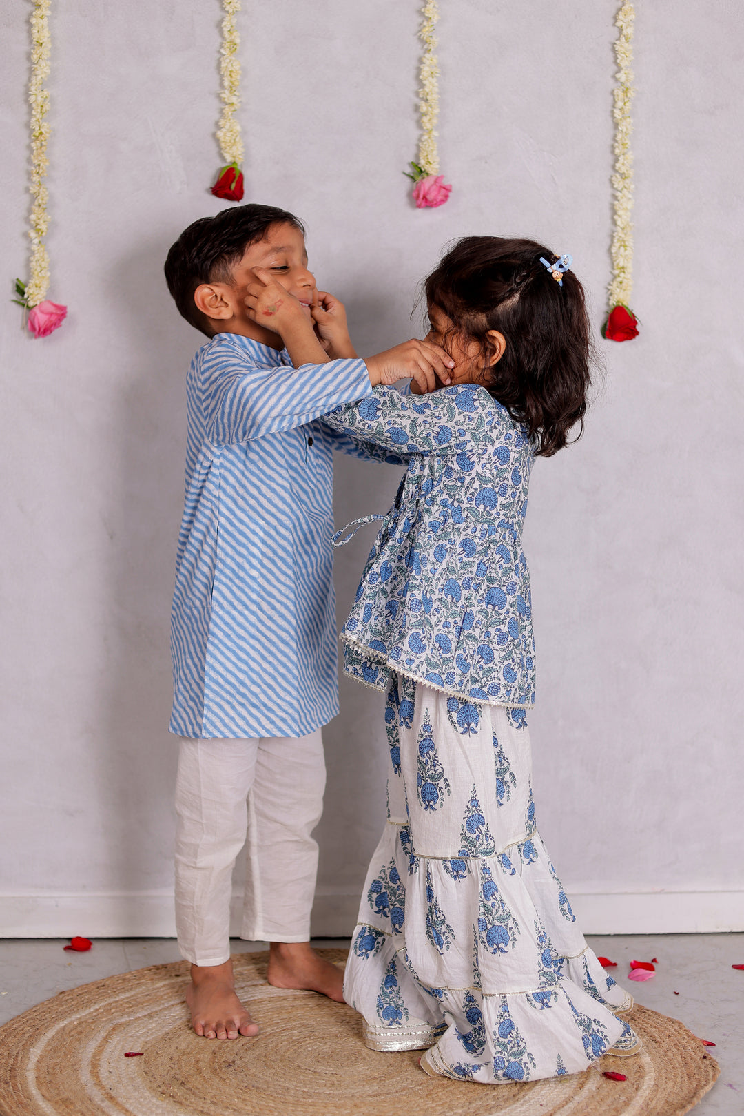 BOYS BLUE LEHERIYA KURTA WITH PAJAMA (SET OF 2) + GIRLS WHITE FLORAL ANGRAKHA KURTI WITH WHITE FLORAL SHARARA (SET OF 2)