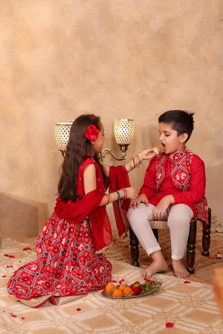 BOYS MAROON PATOLA PRINT JACKET WITH MAROON KURTA AND PAJAMA (SET OF 3) + GIRLS MAROON PATOLA PRINT LEHENGA WITH SLEEVELESS TOP AND DUPATTA (SET OF 3)